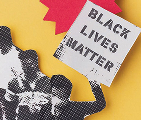 Two young black men wearing medical masks holding a "Black Lives Matter" sign