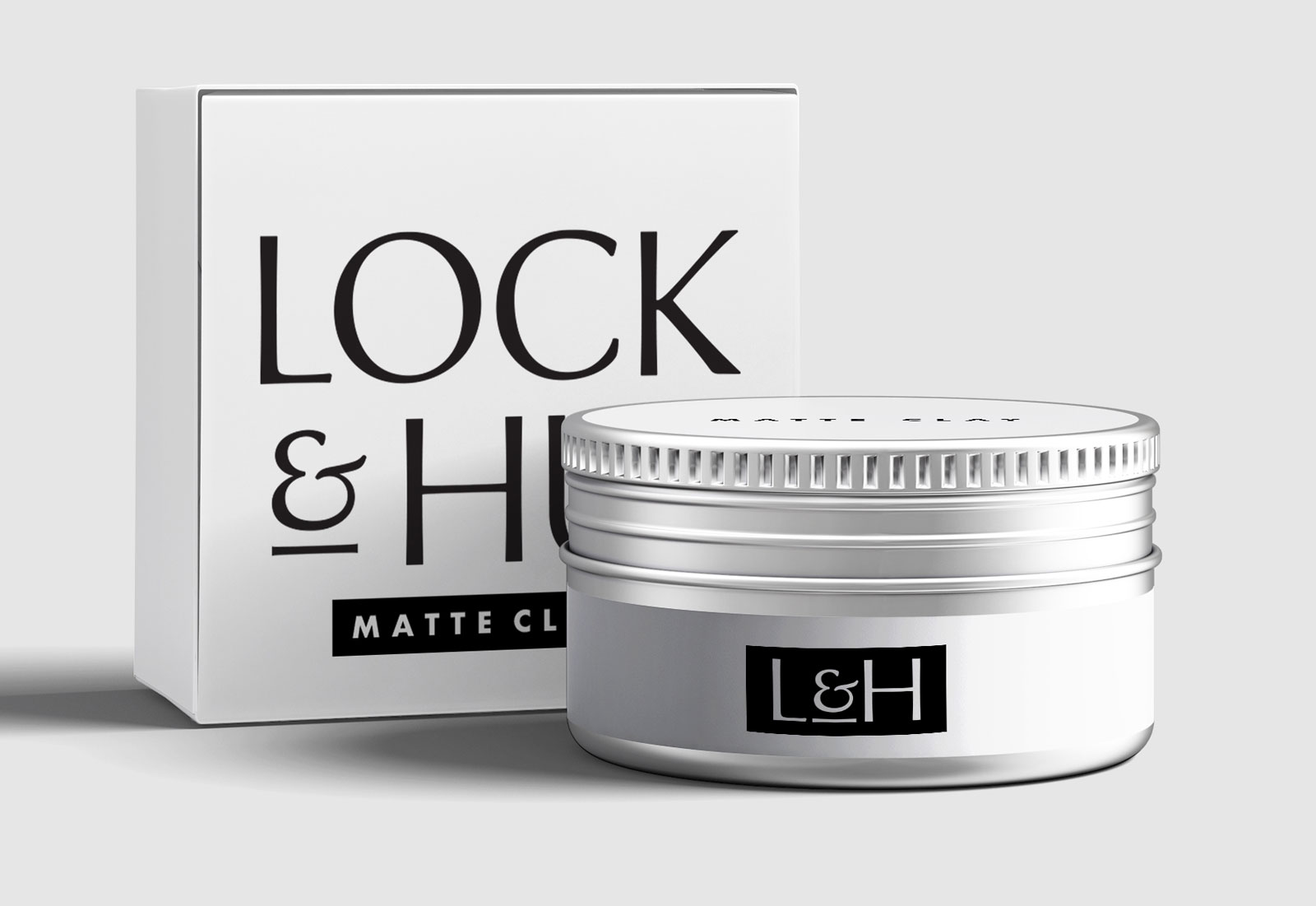 A smal tin jar and a box, both featuring Lock & Hue branding