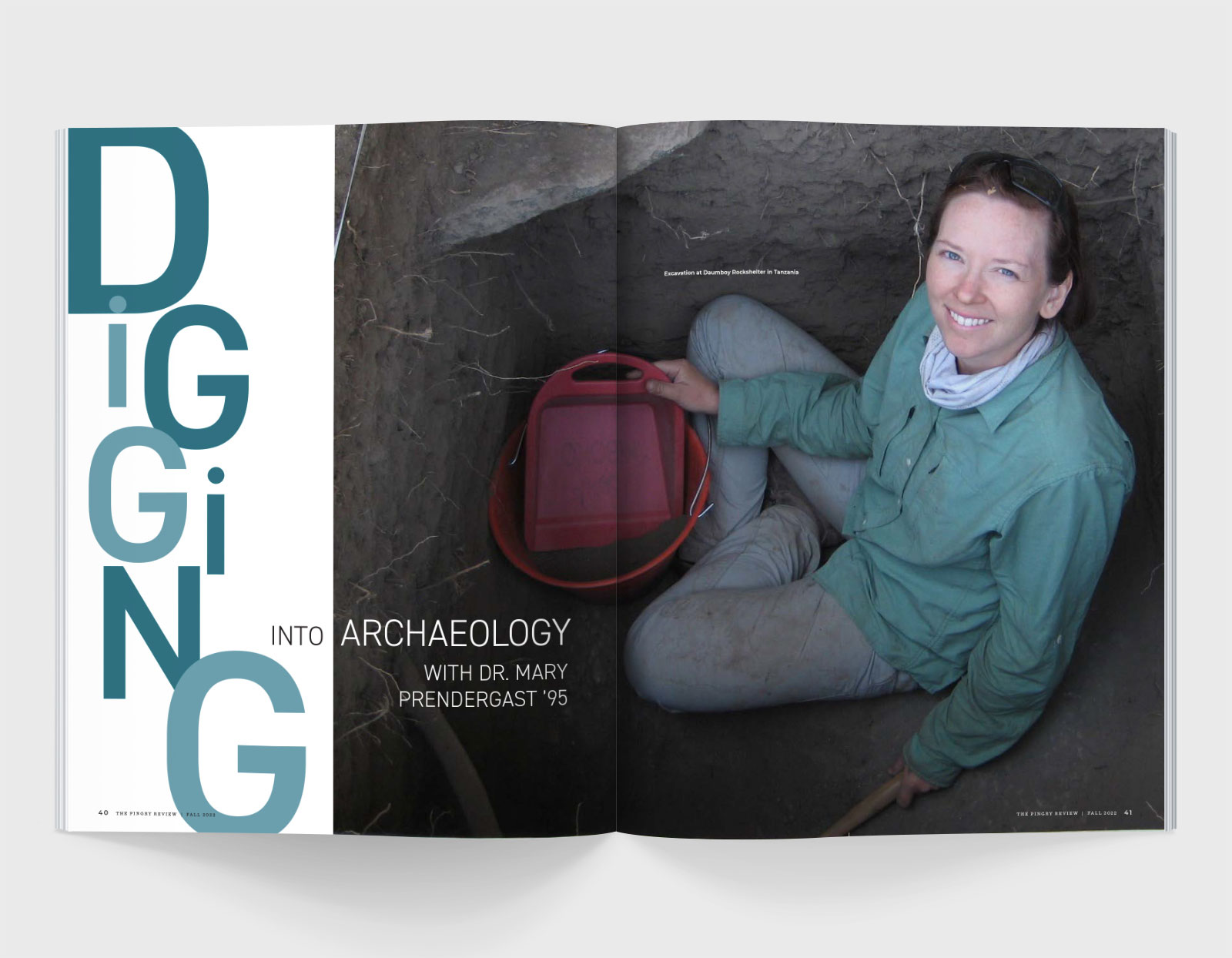 A spread from The Pingry Review featuring a woman archaeologist with a red shovel sitting in a dirt hole and text that reads 'Digging into Archaeology with Dr. Mary Prendergast '95'